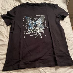 Selling a black shein shirt with a  blue and black butterfly with cool writing.
